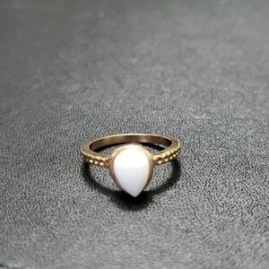 Gold tone ring with white stone